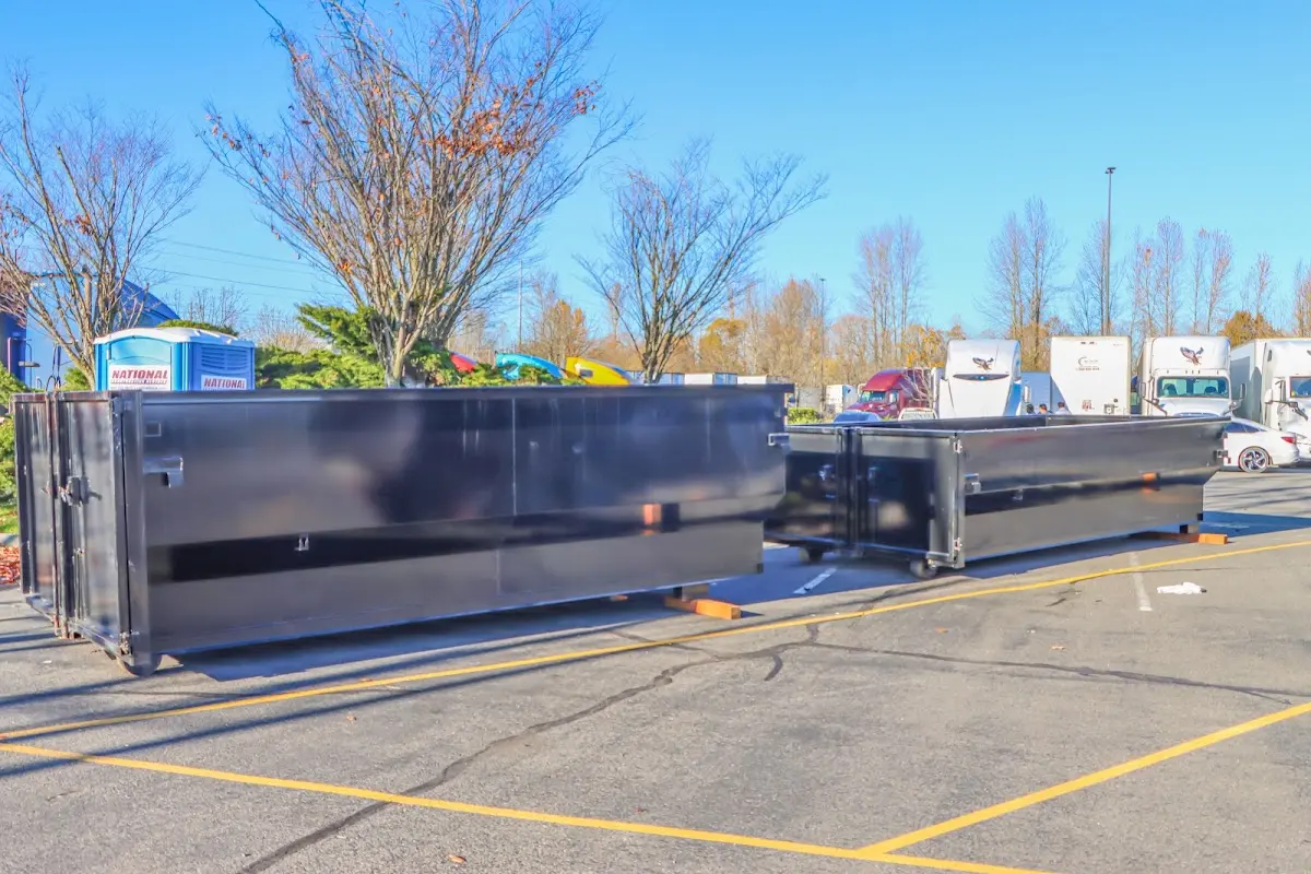 Professional dumpster rental service with roll-off container on residential driveway in Cumru